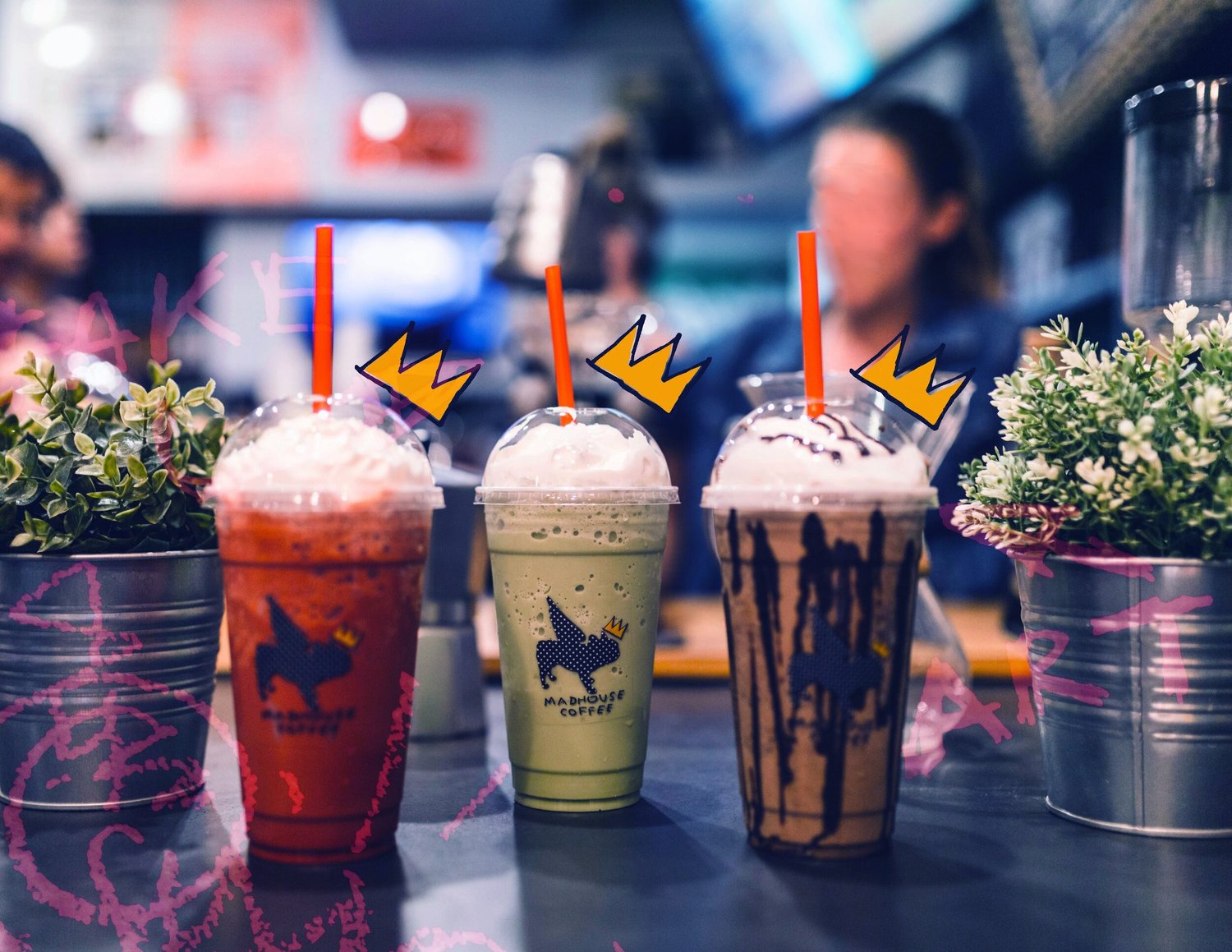 Left to right: Red Velvet Mocha, Pistachio White Chocolate Mocha and Monkey Mocha, in three Madhouse cups with yellow crown artwork