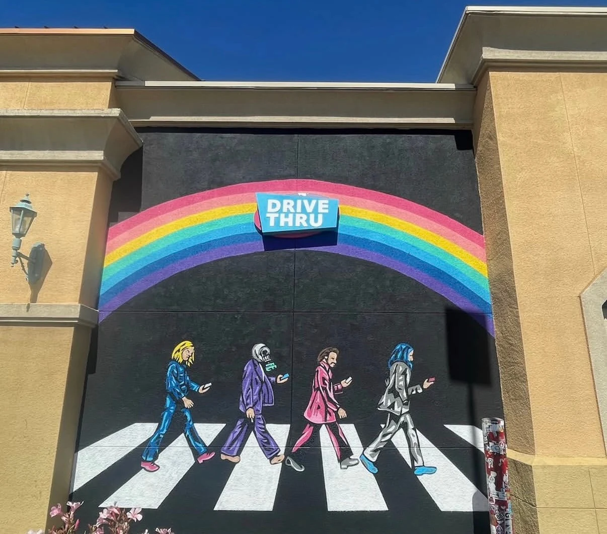 Rainbow Madhouse drive-thru mural with four colorful figures